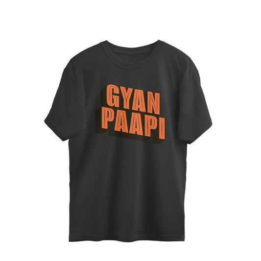 Black oversized t-shirt with GYAN PAAPI printed in orange three-dimensional block letters with a black shadow